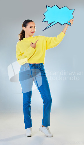 Image of Speech bubble, portrait and woman pointing to chat, social media opinion and confused, translation or communication. Gen z person in doubt, question and language mockup or quote on studio background