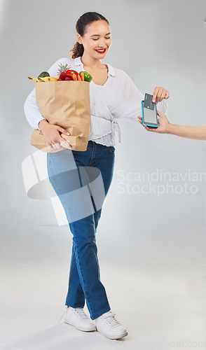 Image of Card machine, grocery shopping and woman for business, POS and shop payment, fintech or digital finance. Groceries, credit and cashier hands, people and food bag at point of sale on studio background