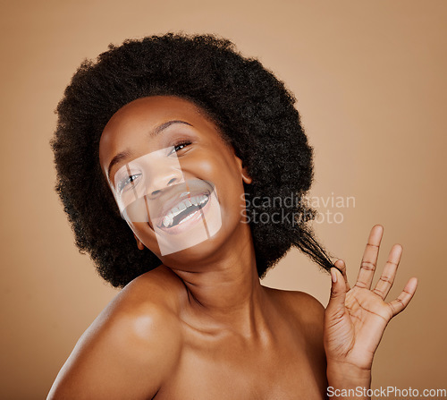 Image of Portrait, smile and black woman pulling hair, growth and wellness against a brown studio background. Face, female person and happy model with beauty, luxury and volume with fun, playful and cosmetics