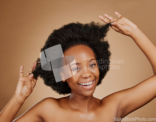 Image of Portrait, beauty and black woman pulling hair, cosmetics and wellness against a brown studio background. Face, female person and model with luxury, playful and volume with fun, texture and shampoo