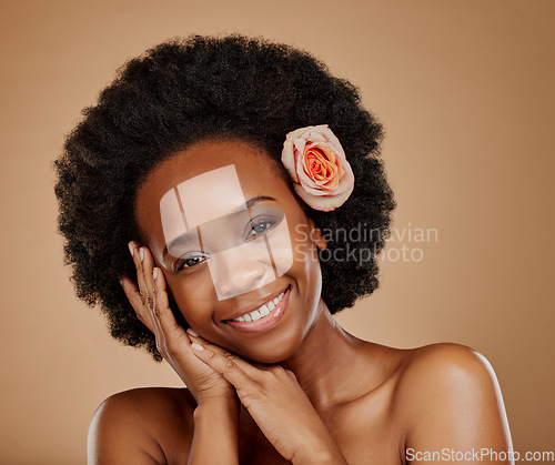 Image of Self care, floral and portrait of woman in studio with beauty, natural and face routine. Skincare, beauty and African female model with flower rose in hair for facial treatment by a brown background.