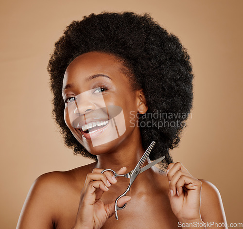 Image of Portrait, happy and black woman cutting hair as hairdresser, damage or maintenance for afro style. Smile, salon and an African girl or model with scissors for hairstyle isolated on studio background