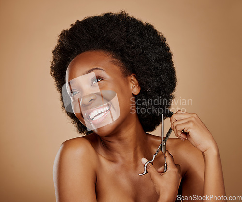 Image of Thinking, happy and black woman cutting hair as hairdresser, damage or idea for afro style. Smile, salon and an African girl or model with scissors for a hairstyle idea isolated on studio background