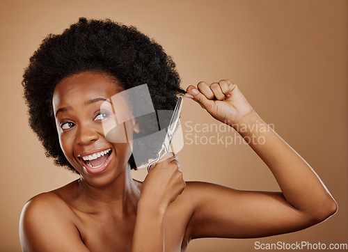 Image of Haircut, scissors or excited black woman with afro in studio on a brown background for positive change. Smile, transformation or happy natural African at hairdresser salon for hairstyle or beauty