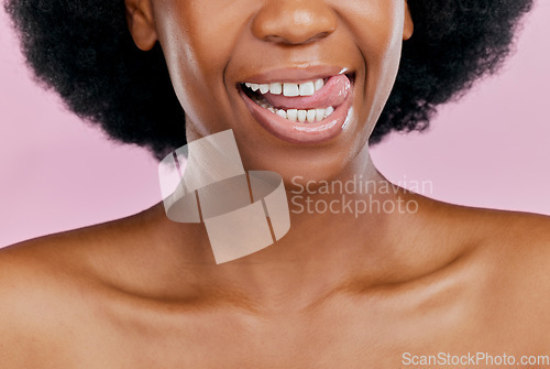 Image of Black woman, mouth and tongue out, beauty and teeth with dental, health and hygiene on pink background. Lips, skin and African female model, oral care and grooming with healthy gums in studio