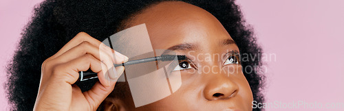 Image of Eyes, mascara and brush, makeup and black woman, beauty and cosmetic product on pink background. Female model, hand and eyelash extension, cosmetology and lashes transformation with glow in studio