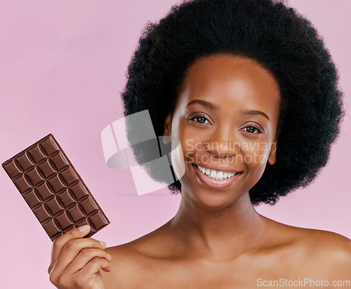 Image of Portrait, chocolate and black woman with a smile, natural beauty and dessert on a studio background. Face, female person or Jamaican model with sweets, cocoa candy or delicious snack with sugar treat