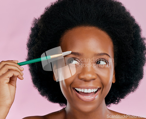 Image of Makeup, face and black woman with mascara, excited and beauty in studio isolated on a pink background. Brush, eyebrow cosmetics and happy African model apply facial treatment, wellness or aesthetic.