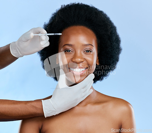 Image of Black woman, face injection and beauty with treatment, cosmetic procedure, fillers and dermatology on blue background. Liquid collagen, facial and skincare, hands and female model in portrait