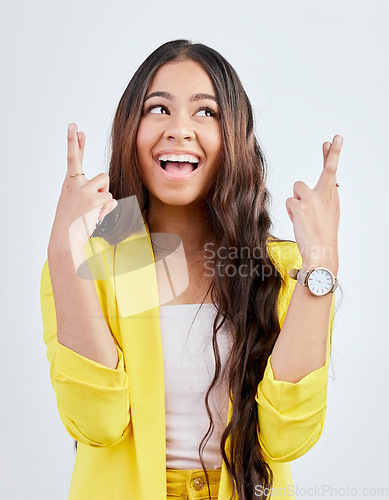 Image of Hope, fingers crossed and face of woman in studio with hand gesture for winning, good luck and wish. Winner, white background and excited female person for competition, promotion and lottery bonus