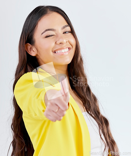 Image of Portrait, support and woman with thumbs up, promotion and success against a white studio background. Wink, female person or model with hand gesture, achievement or like with symbol or positive review