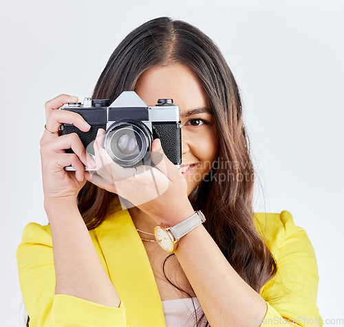 Image of Creative, portrait and a woman with a camera for a photo, memory or career in photography. Happy, paparazzi and a young girl or photographer taking a picture isolated on a white background in studio