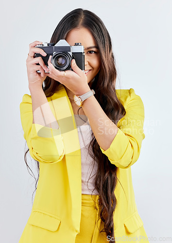 Image of Smile, portrait and a woman with a camera for a photo, memory or career in photography. Happy, paparazzi and a young girl or photographer taking a picture isolated on a white background in studio