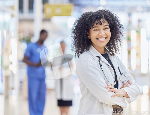 Image of Doctor, portrait and woman smile with arms crossed in hospital for healthcare, wellness and pride for career. Face, confidence and African medical professional, surgeon or happy employee in clinic.