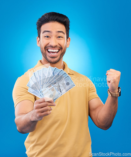 Image of Money, fist pump portrait and man excited for dollar bills, financial achievement award or bonus salary prize. Show cash, happy winner and person cheers for income, revenue or win on blue background