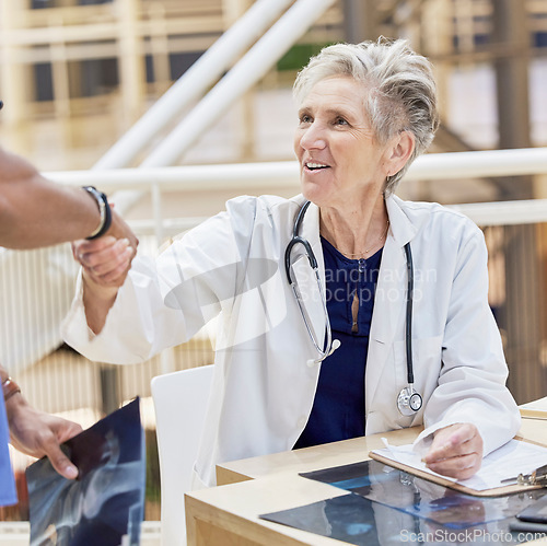 Image of Senior doctor, shaking hands and introduction, thank you and congratulations with gesture and health. Welcome, communication and support in medicine, female medical professional and handshake