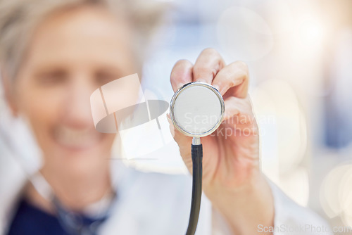 Image of Hand, stethoscope and doctor listening to heart for healthcare in wellness hospital. Medical professional, expert and cardiology equipment, tools or exam to monitor pulse for health checkup in clinic