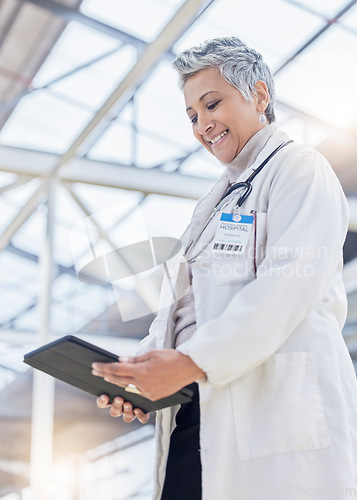 Image of Doctor, woman and smile with tablet for medical information, data research or healthcare in hospital. Happy female employee, digital technology and planning telehealth, internet app or online results