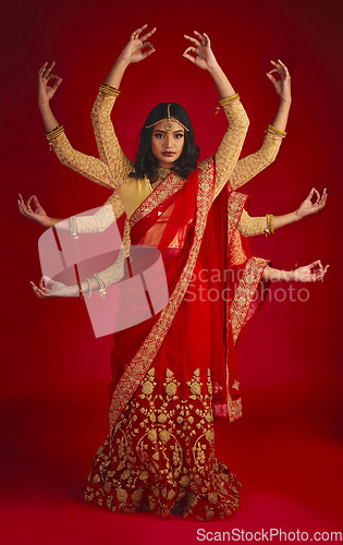 Image of Indian woman, studio and culture with mudra, portrait and magic for culture, yoga and fashion by red background. Girl, model and beauty for fantasy, jewellery and art with clothes for festive event