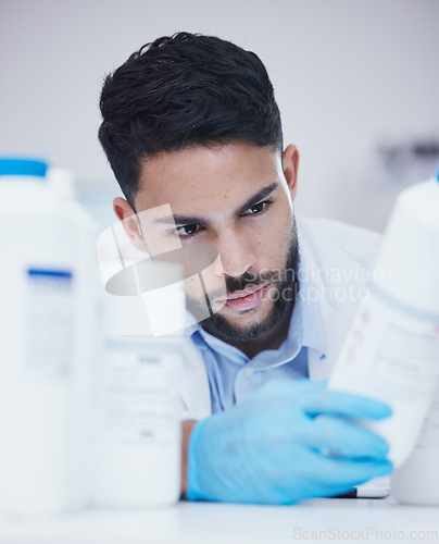 Image of Laboratory, man or scientist reading bottle to check medical stock or info on cure breakthrough. Research study, container label or science researcher in manufacturing job with chemical inventory