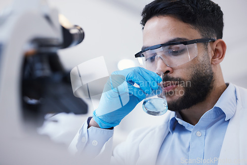 Image of Man, smell or scientist with liquid to research for a test analysis, experiment or medical innovation. Beaker, studying biotechnology or researcher sniffing in laboratory for science development