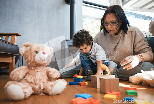 Image of Toys, family or kids with a mother and son playing in the bedroom of their home together for child development. Children, teddy bear or education and a boy learning motor skills with a woman parent