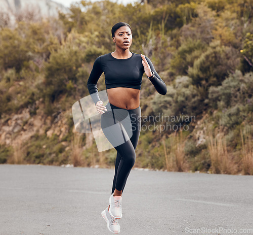 Image of Mountain, running and woman for fitness, exercise and speed training, outdoor challenge and focus on road. Fast professional runner, athlete or african sports person for cardio workout or marathon