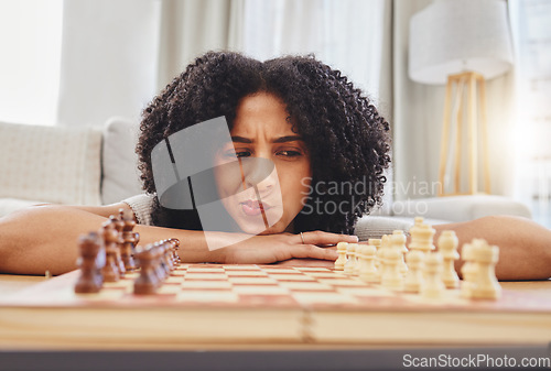 Image of Chess, thinking and portrait of woman with board for strategy, problem solving and challenge at home. Competition, ideas and female person with chessboard in living room ready for playing games