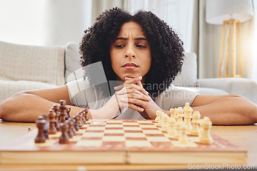 Image of Thinking, strategy and face of woman with chess for problem solving, planning and challenge at home. Competition, contest and female person with chessboard in living room ready for playing games