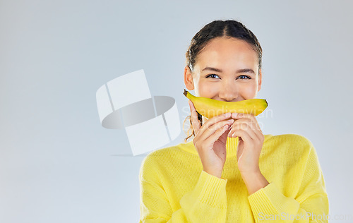 Image of Happy, banana and portrait of woman with fruit in studio for healthy eating, wellness and diet. Food, lose weight and mockup person on white background with fruits for nutrition, detox and digestion