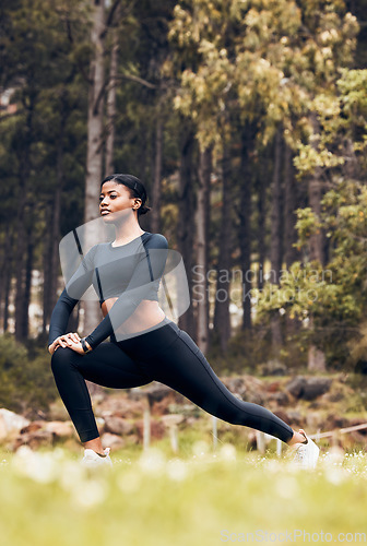 Image of Stretching, fitness and black woman lunge in nature for exercise, training and sports in forest. Hiking, mountain and female person stretch legs for warm up, workout and wellness for performance