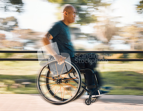 Image of Man with a disability, wheelchair and motion of exercise in the park, nature or athlete in outdoor fitness training. Blurred background, sport and disabled person exercising or speed on wheels