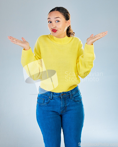 Image of Portrait, confused woman and shrug in studio, white background or question of choice, emoji or puzzled reaction. Female model, body language and dont know why in doubt, uncertainty or forgot decision