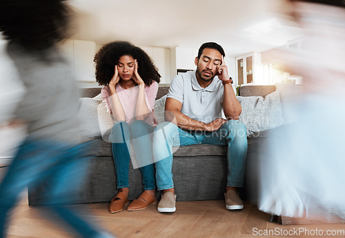 Image of Kids running with stressed parents on the sofa to relax in the living room of their house. Upset, burnout and excited children playing with blur motion on couch with tired exhausted mother and father