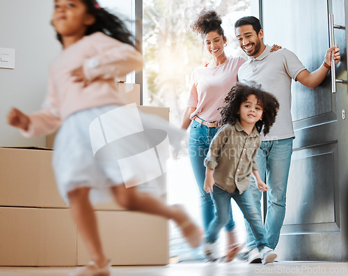 Image of Happy, moving and parents with children running in their new modern family house with excitement. Happiness, smile and young mother and father watching their kids jumping in blur motion at their home