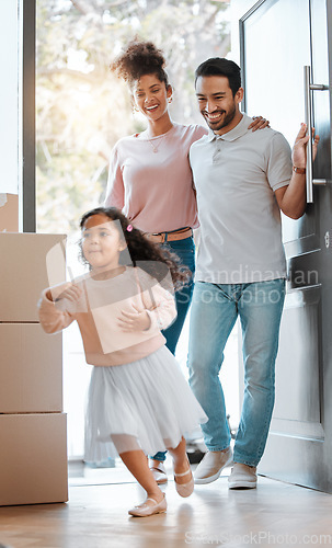 Image of Happy family, real estate and moving in new home for investment, property or fun relocation by door. Father, mother and daughter smile playing in house for mortgage loan, renovation or beginning