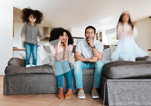 Image of Children jumping with stressed parents on the sofa to relax in the living room of their house. Upset, burnout and excited kids playing with blur motion on couch with tired exhausted mother and father