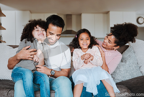 Image of Mother, father and kids on sofa, playing and happy family bonding together in living room. Smile, happiness and parents relax with kids on couch, spending playful and quality time in home on weekend.