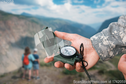 Image of Man with compass in Altai mountains