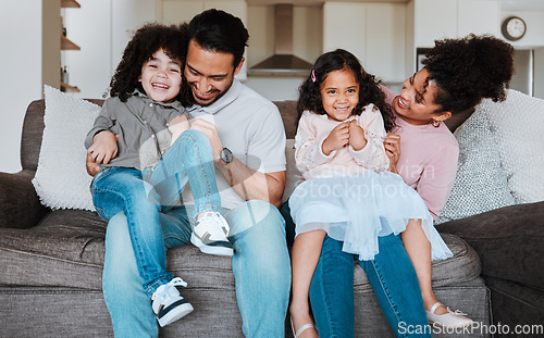 Image of Mother, father and kids on sofa, playing and happy family bonding together in living room. Smile, happiness and parents relax with young children on couch, playful and spending quality time in Mexico