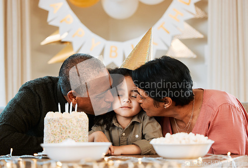 Image of Birthday, cake and grandparents kiss child in living room for event, party celebration and social gathering. Happy, surprise and grandma, grandpa and kid with dessert, snacks and presents at home