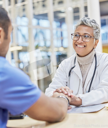 Image of Smile, support and doctor holding hands with patient at consultation for healthcare and empathy in office. Happy woman, man and helping hand in medicine, trust and comfort in medical care at hospital