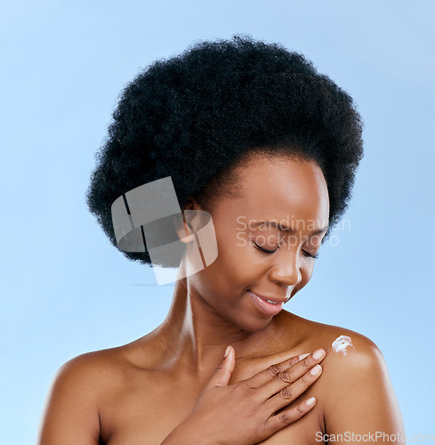 Image of Black woman, cream and beauty, body care and cosmetics with moisturizer isolated on blue background. Dermatology, African model and sunscreen with skincare, afro hair and wellness with grooming