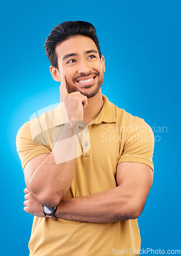 Image of Thinking, studio or man brainstorming, smile or happy for memory, inspiration plan or solution ideas. Planning, remember or Asian person wondering about thought, decision or choice on blue background