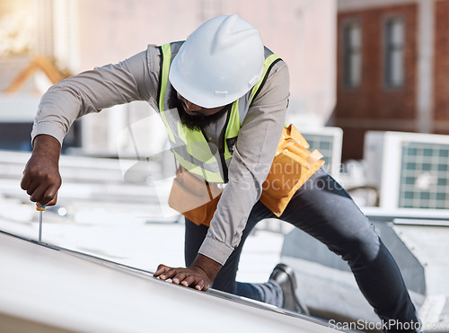 Image of African engineer man, screwdriver and solar energy on rooftop, maintenance and industry for thinking in city. Technician, builder and tools for photovoltaic tech, helmet and sustainability in metro