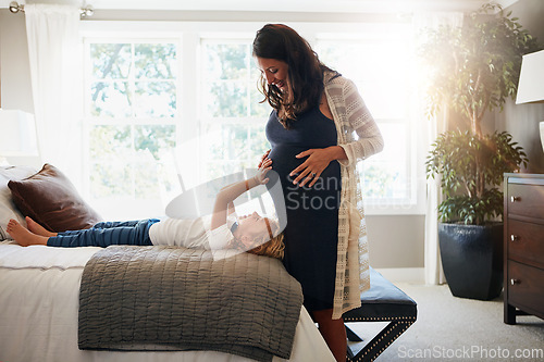 Image of Home bedroom, pregnant woman and child touch, feel or massage stomach or excited for baby movement. Expectation, maternity and relax kid check life growth, pregnancy or belly of mother or mom on bed