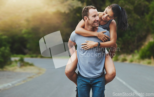 Image of Love, piggyback or happy couple walking on road or outdoor date for care, support or loyalty. Freedom, romantic man or woman on holiday vacation together to relax or smile on street for wellness