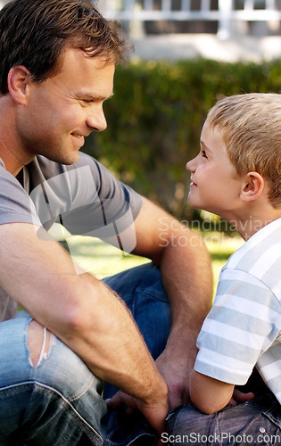 Image of Smile, father and boy sitting on grass, cute bonding together with care and love in home backyard. Outdoor fun, dad and child on lawn in garden, playful with trust and support with happy man and son.