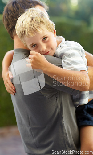 Image of Portrait of dad hugging kid in backyard, support and bonding together in comfort, care and love. Smile, father and face of child in garden with happy relationship, trust for man and boy or family