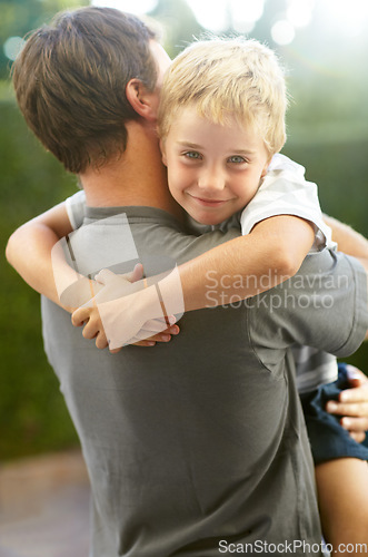 Image of Portrait of father hugging child in backyard, cute bonding together in care and love in garden. Outdoor fun, support and dad holding playful son with smile, trust and happy man with kid at playground